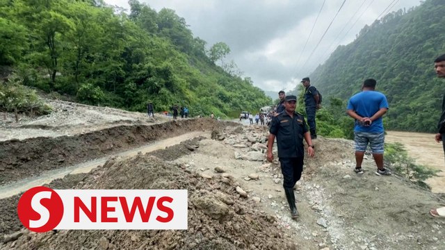 Scores in Nepal still missing after landslide plunges buses with passengers into river