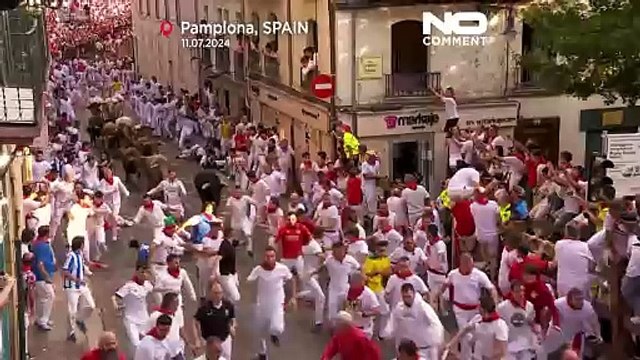 Centenas de pessoas correm à frente de touros bravos pelo bairro antigo de Pamplona