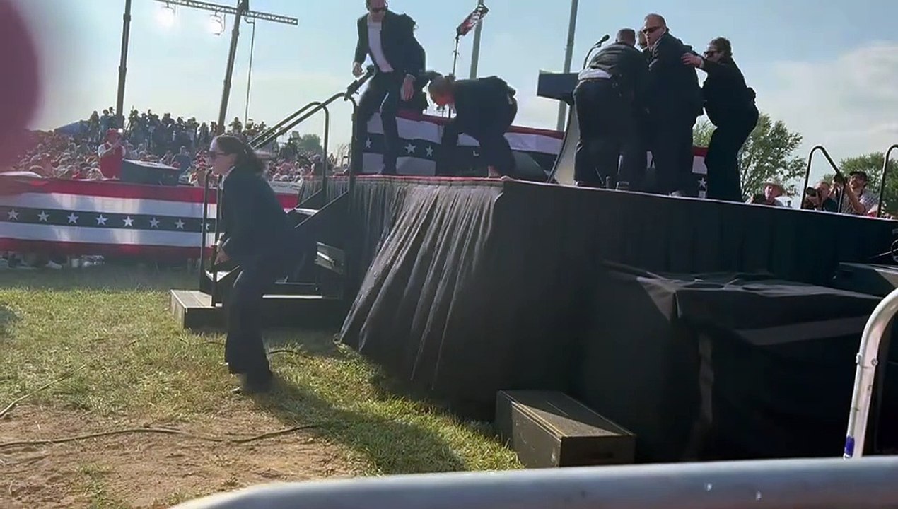 *EXPLICIT LANGUAGE* - Video from the Donald Trump rally in Butler, Pa. of Trump being surrounded by Secret Service agents after gunshots were fired that killed one man and injured the former President and two others. (Obtained by WBEN from Rich in Angola)