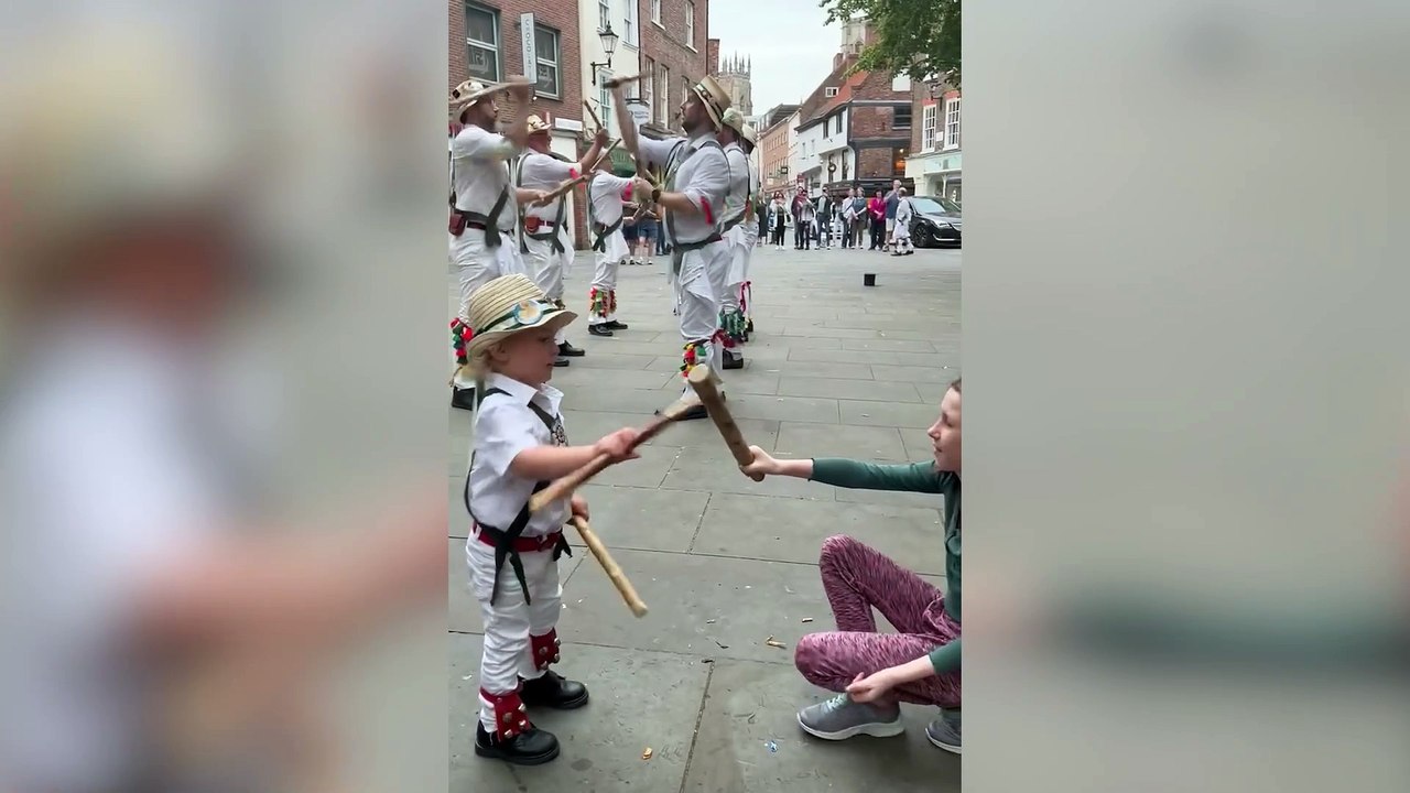 Two-year-old boy dances along with father’s Morris dance group