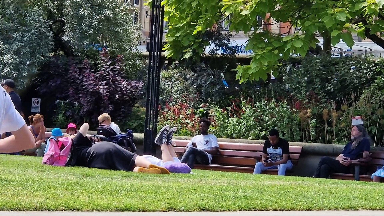 People of Sheffield bask in the sun at the Peace Gardens