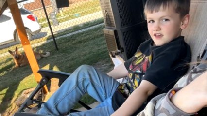 Funny backyard moment: Boy falls out of chair while relaxing with mom