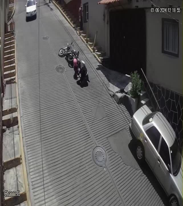 Biker and Pillion Rider Fall Off as Motorcycle Rolls Backwards Downhill