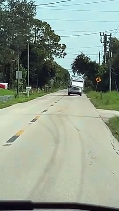 Car_With_Three_Mattresses_Tied_to_Roof_Drops_One_in_Middle_of_Road(1)