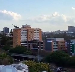 RAAF C-17 maneuvering at low altitude over Brisbane