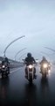 Group Of Riders Riding On Wet Roads On A R