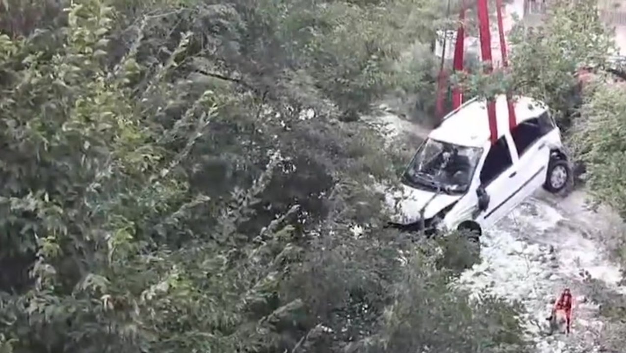 Woman and two children rescued as car falls from bridge in Italy