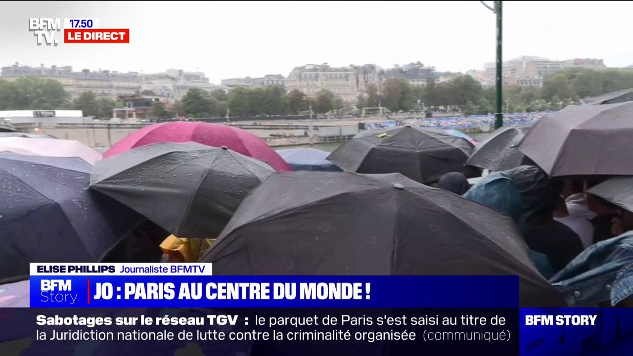 "Malgré la pluie, l'ambiance est superbe": les parapluies sont de sortie avant le début de la cérémonie d'ouverture des JO