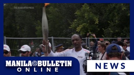 Snoop Dogg carries Olympic torch in Saint-Denis