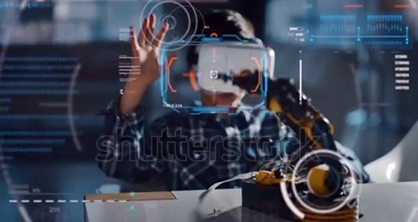 Portrait of boy playing with mechanical arm toy using vr glasses with futuristic augmented reality hologram in living room in slow motion.