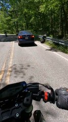 Motorcyclist Nearly Crashes Into Moving Car