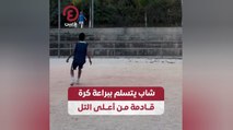 شاب يتسلم ببراعة كرة قادمة من أعلى التل