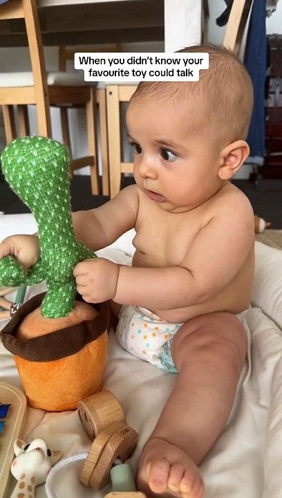 baby with cactus toy