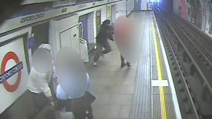 Man shoves stranger onto tracks as train arrives at platform