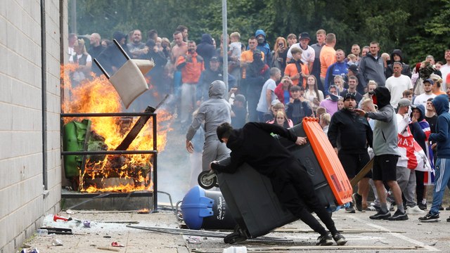 Hundreds of far-right protesters clash with cops outside migrant hotels