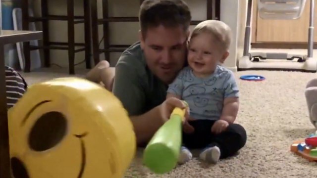 Dad and son enjoy playtime with a smiley balloon and endless giggles