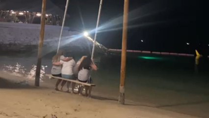 Man records DISASTROUS outcome of 4 friends trying to share a beach swing