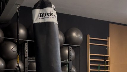 Gym enthusiast's unexpected fall while kicking bag in socks after training