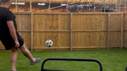 Football lover's smooth kick sends friend tumbling off the fence