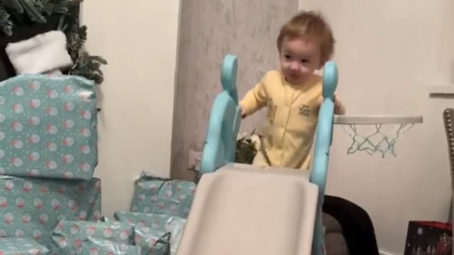 Toddler excitedly climbs indoor slide for the 1st time, only to experience a funny backward fall