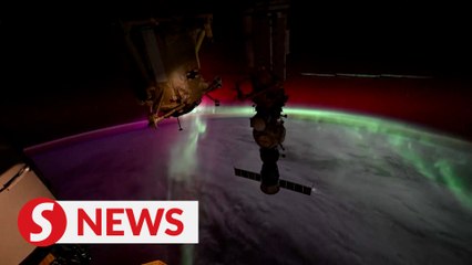 Watch video from space of the moon setting into auroras
