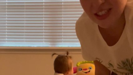 Mom uses selfie mode to inspire the baby girl to crawl and explore