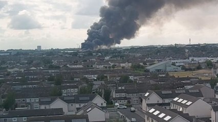 Intimidating view of massive smoke plume rising from fire-damaged area in Clonshaugh, Dublin