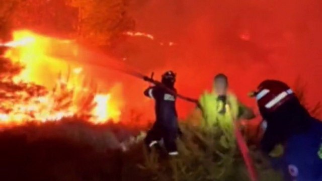 Dramatic footage shows firefighters battling massive wildfires near Athens