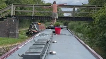 'Comedic Bridge Jump Fail' - Man misses boat and ends up hanging