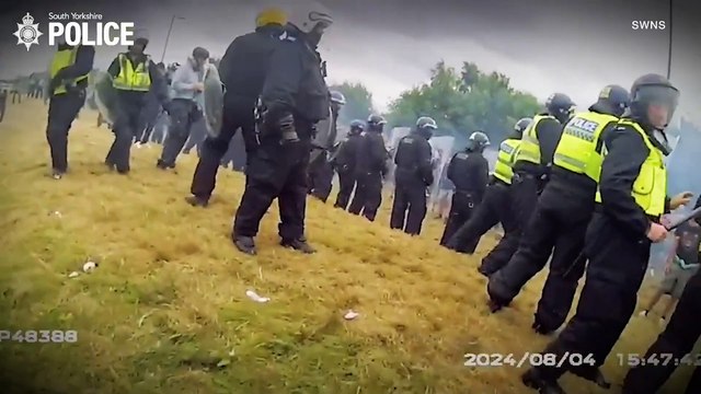 Watch moment thug tries to topple police van draped in England flag