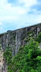 The car was driving on a cliff road that was as sharp as a knife.