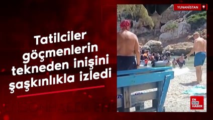 Yunanistan'da tatilciler göçmenlerin tekneden inişini şaşkınlıkla izledi