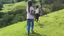 Family walk takes an unexpected turn as little girl tumbles down a hill