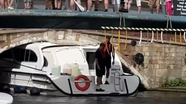 Video shows crowds gathering as boat gets stuck under bridge on idyllic Broads