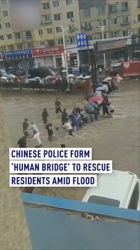 Chinese police form 'human bridge' to rescue residents amid severe flood
