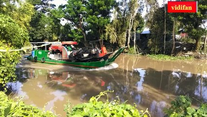 transporting combine harvesters on the river