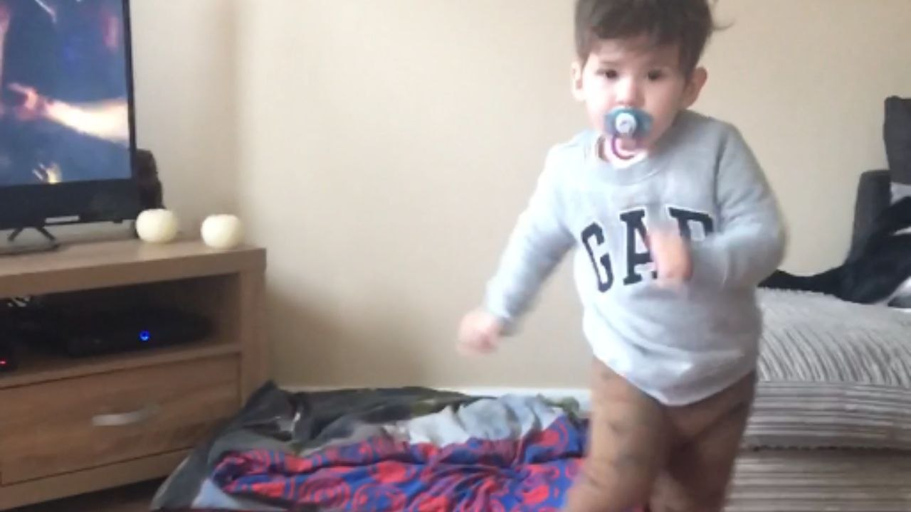 Little boy’s dancing comes to an end when dog pushes him to the floor