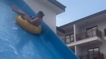 Woman gets silly on waterslide to bring laughter to her husband and son