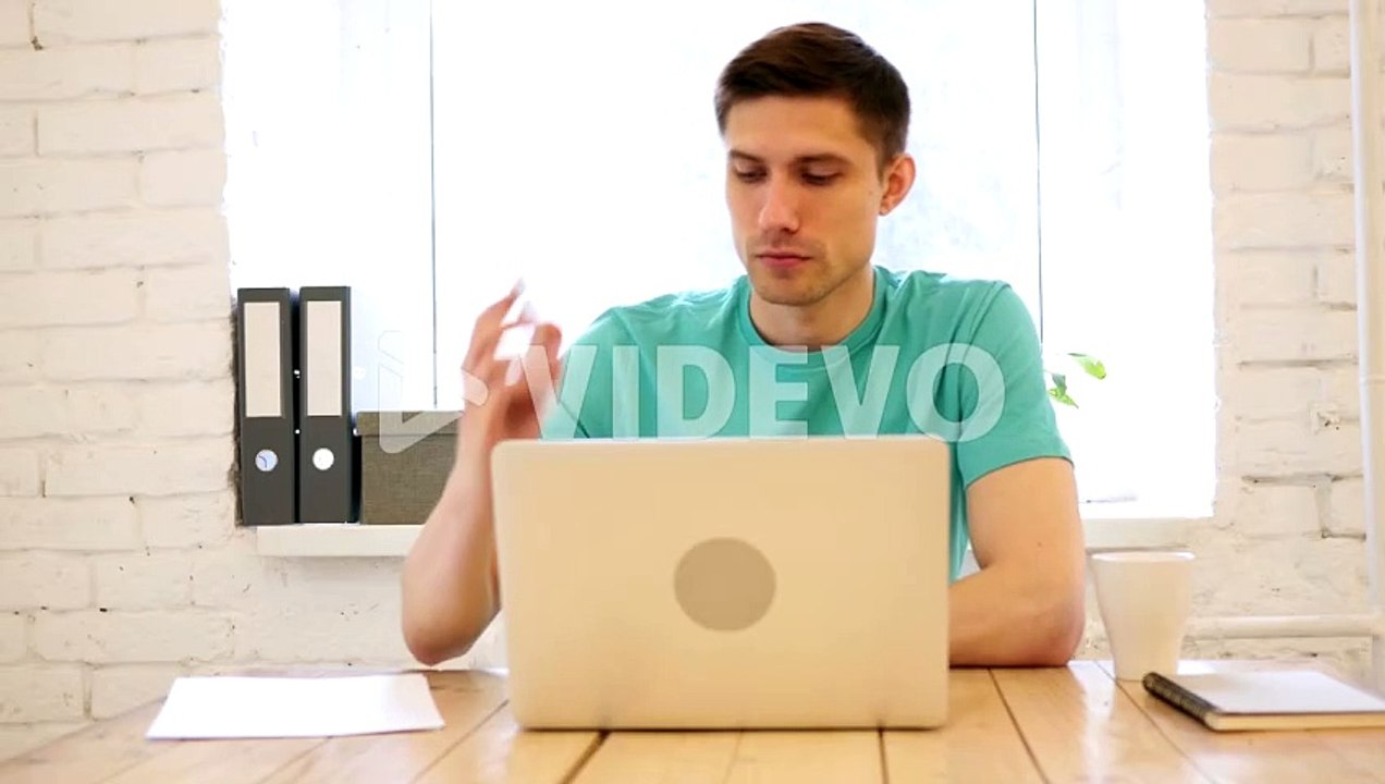 Man Talking on Smart Phone in His Office