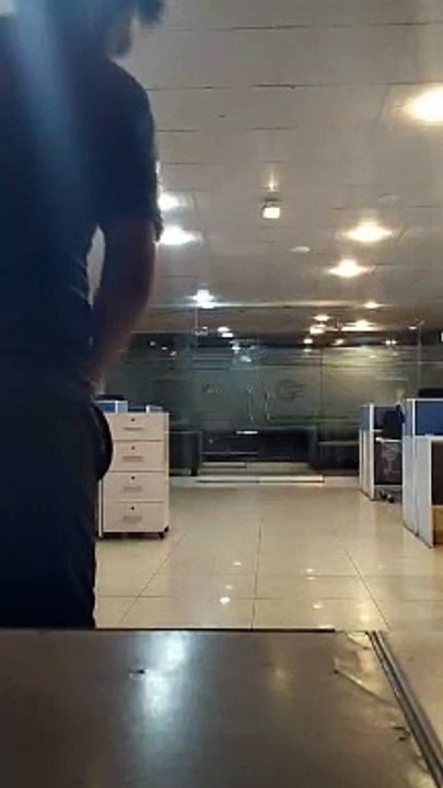 A young boy bowling in a office