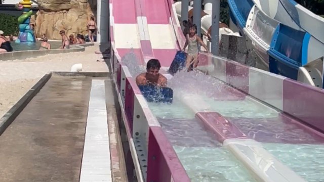 Waterslide race between brothers ends in a sudden collision with a little girl