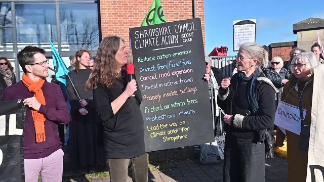 Climate activists with grave stones and a coffin, protest in Shrewsbury.