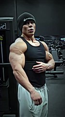 A boy in gymnastics is showcasing his arm muscles.