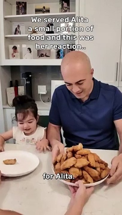 Serving my daughter a small portion of food to see her reaction.