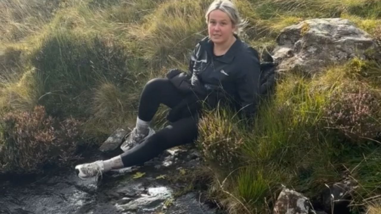 Girl falls after attempting to slide down wet rock on hike