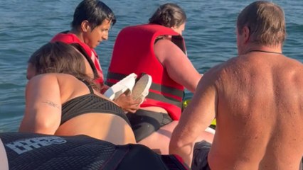 Couple comically falls into the water after jet ski tips over