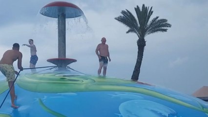 Family creates splashing memories on an inflatable balloon at the resort