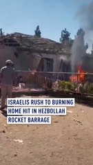 Israelis rush to burning home hit in Hezbollah rocket barrage