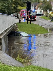 Footage of young boy cleaning drain in major floods