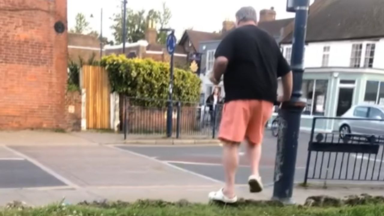Man sits next to girl in a strange manner and falls as he walks away